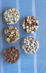 Healthy food. Nuts mix assortment on stone texture top view. Collection of different legumes for background image close up nuts, pistachios, almond, cashew nuts, peanut, walnut. image