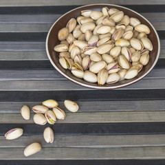 Healthy food  for background image close up pistachios nuts. Texture on top view Nuts pistachio on the cup plate
