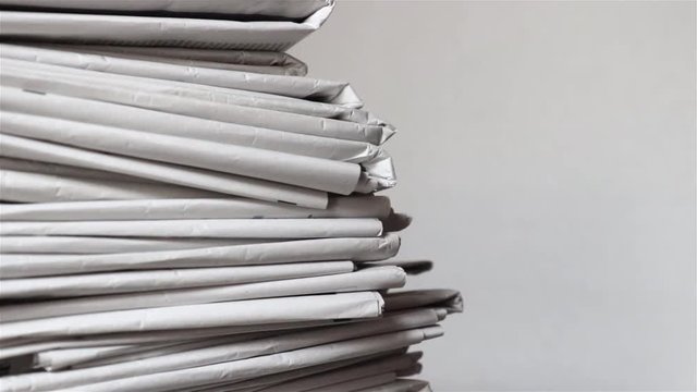 stack of newspapers, tracking shot of a pile of journals