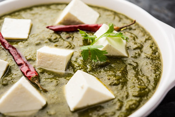 Palak Paneer Curry made up of spinach and cottage cheese served in a bowl. selective focus