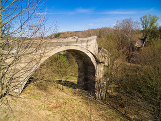 Destroyed railway bridge over Sapina river, Kruklanki town in the background, Poland (former Kruglanken, East Prussia)