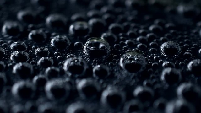 Close-up of bubble soda on black background in 4K resolution