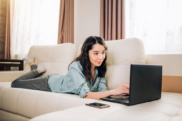 Bbeautiful woman using laptop computer at home on sofa