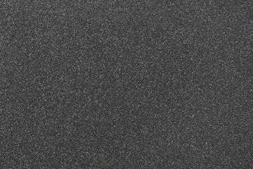 fragment of grainy black plastic surface