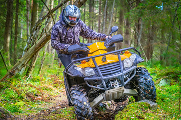Quad biking. A stressful man rides a quad bike through the mud. Off-road riding on ATV. Turn on abyss on the ATV. Active sports. Extreme. Quad bike rental. © Grispb