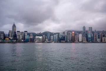 Beautiful panorama view of business district of hong kong city and river on overcast and clouds sky background