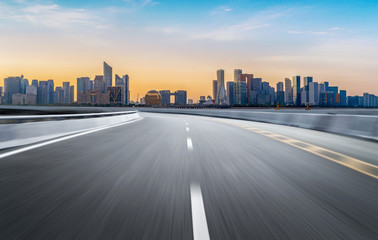 Fototapeta premium Empty road floor surface with modern city landmark buildings of hangzhou bund Skyline,zhejiang,china