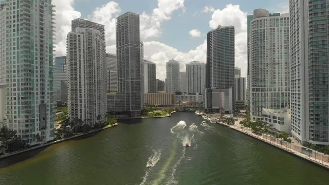 Boats on Miami River surrounded by business buildings at Downtown Miami, Brickel Aerial view of boats on Miami River surrounded by business buildings at Downtown Miami and Brickel