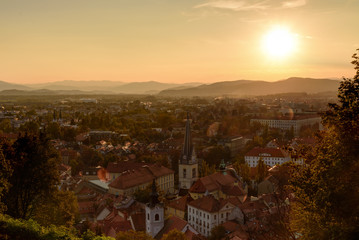 Fototapeta na wymiar View of Ljubljana city and mountain rnge as background at sunset with dramatic cloudscape, Slovenia