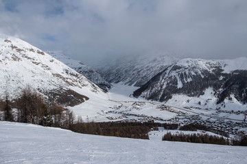 Fototapeta premium Winter view from the top on Livigno city and lake Livigno. Italy.
