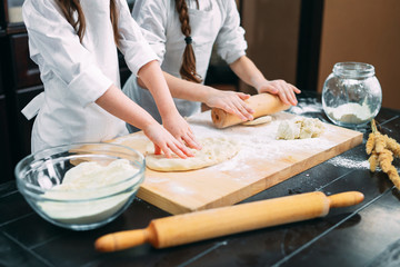 funny girls kids are preparing the dough in the kitchen.