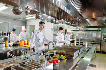 Modern kitchen. The chefs prepare meals in the restaurant's kitchen.