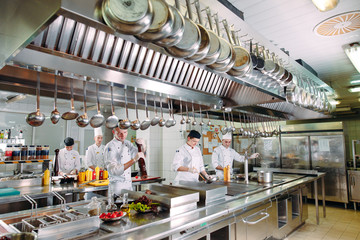Modern kitchen. The chefs prepare meals in the restaurant's kitchen.