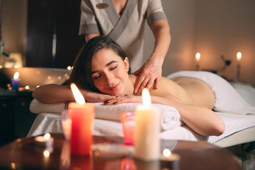 Spa, massage. Young dark-haired beautiful girl doing massage.