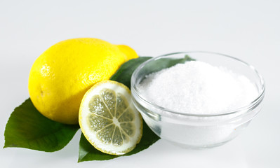 Lemon acid and lemon fruits on the white background.