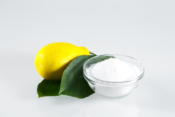 Lemon acid and lemon fruits on the white background.