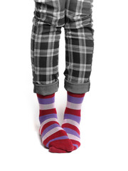 Women's legs in plaid pants and striped socks.