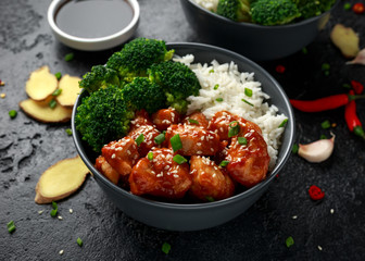 Teriyaki chicken, steamed broccoli and basmati rice served in two Asian clay bowls