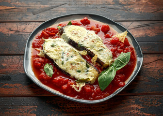 Grilled aubergine, eggplant topped with parmesan cheese crust on crashed tomatoes. Vegetarian pizza version