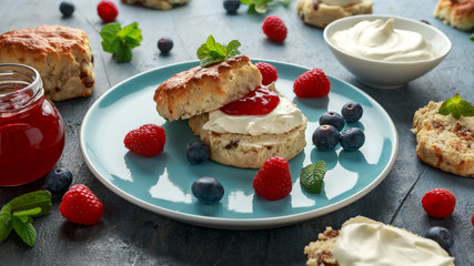 Classic English scones with clotted cream, strawberries jam and other fruit