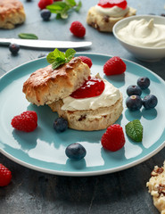 Classic English scones with clotted cream, strawberries jam and other fruit