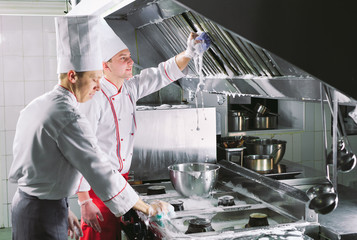 Sanitary day in the restaurant. Repeats wash your workplace. Cooks wash oven, stove and extractor...