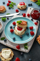 Classic scones with clotted cream, strawberries jam, english Tea and other fruit