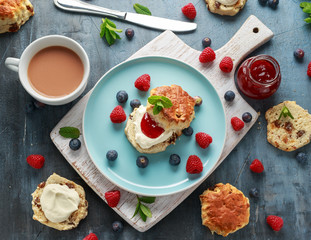 Classic scones with clotted cream, strawberries jam, english Tea and other fruit