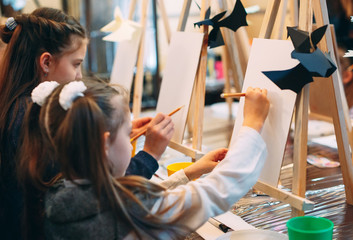 group lesson in drawing. Children learn to draw in the classroom.