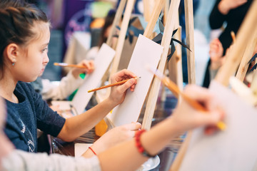 group lesson in drawing. Children learn to draw in the classroom.