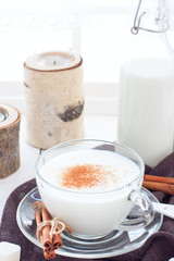 Homemade kefir in a glass cup with cinnamon and sugar, selective focus