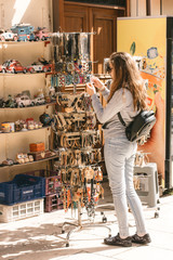 Young pretty girl chooses traditional jewelery at the Turkish bazaar in the old city in Antalya