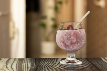 A glass of juice covered in icy sweat is prepared to beat the heat.