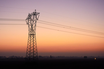 high voltage pylon at sunset