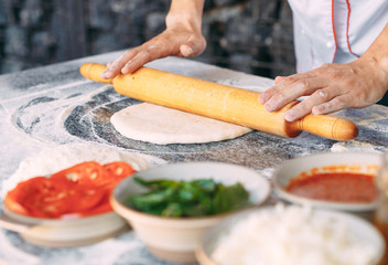 Cooking Pizza. Pizza ingredients on the  table.