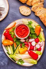 Plate with fresh, raw vegetables and sauce.