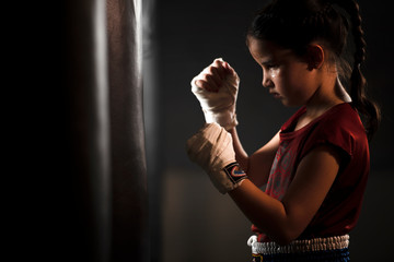 The female child in the boxing glove near the old punch bag The concept of martial arts and myself