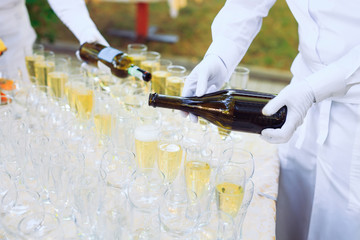 Bartender pouring champagne into glasses