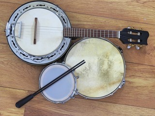 Three Brazilian musical instruments: samba banjo, pandeiro (tambourine) and tamborim with drumstick...