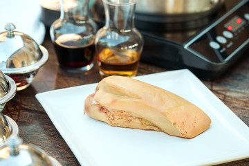 Goose liver on a wooden Board in the restaurant before cooking.