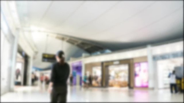 blur background Time lapse of passengers people walking in Duty Free at Airport terminal building