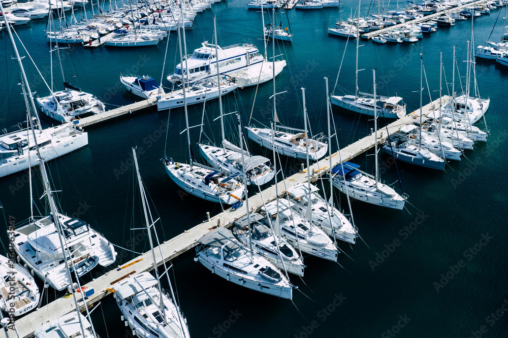 Canvas Prints Aerial view of a lot of white boats and yachts moored in marina. Photo made by drone from above.