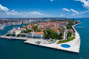 Aerial view of city of Zadar. Summer time in Dalmatia region of Croatia. Coastline and turquoise water and blue sky with clouds. Photo made by drone from above. - obrazy, fototapety, plakaty