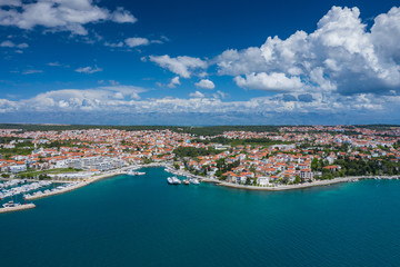 Naklejka na ściany i meble Aerial view of city of Zadar. Summer time in Dalmatia region of Croatia. Coastline and turquoise water and blue sky with clouds. Photo made by drone from above.