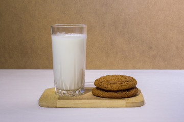 Milk and cookies on a wooden board