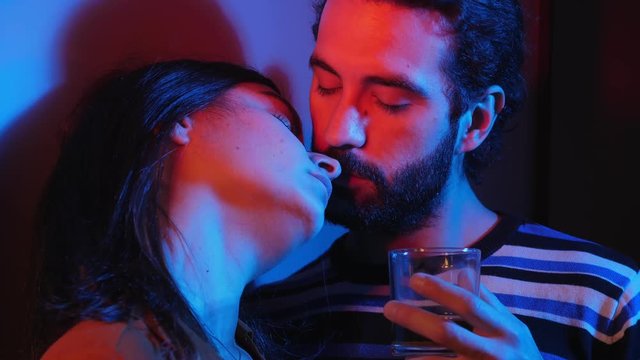  Young drunk  lovers flirting and kissing in the dark.attraction,flirt,seduction