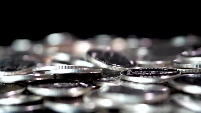 Slow motion close up falling coin on black background (Thai currency, THB coin)