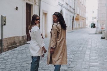 Two elegant beautiful women walking on the street