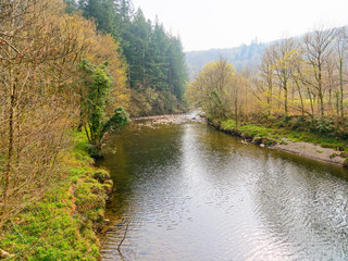 Fototapeta premium Down the River Mawddach, in Gwynedd, Wales on a hazy spring day.
