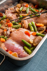 Prepared for baking chicken meat with vegetables.